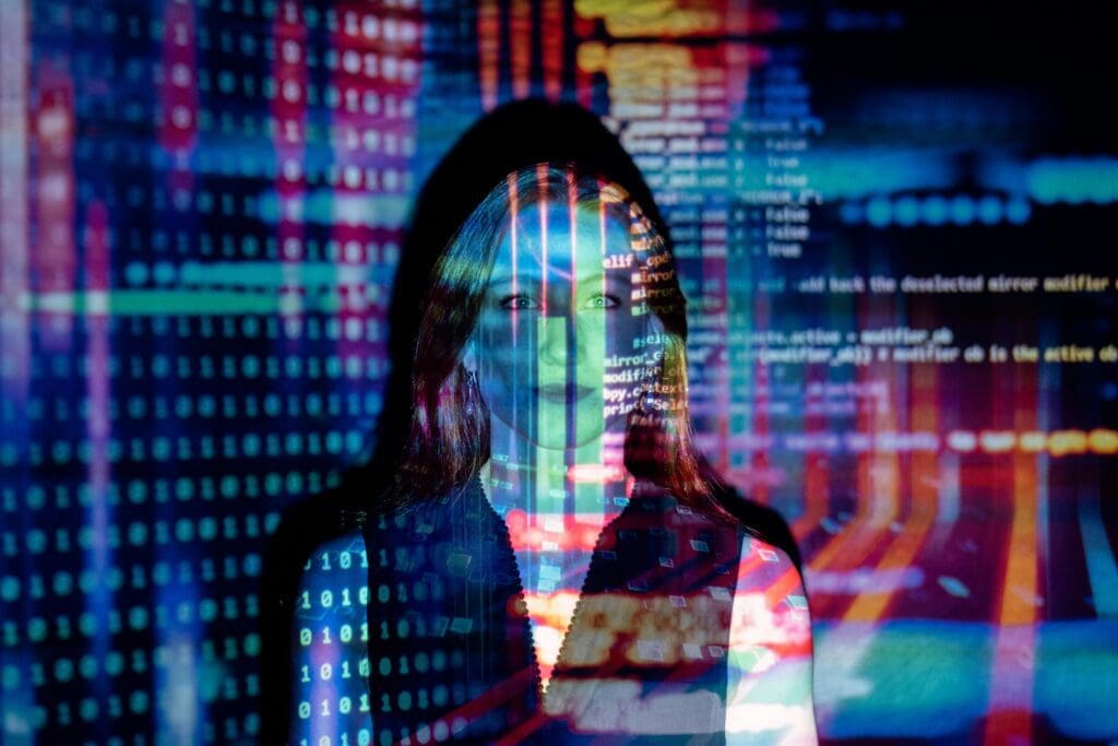 Image of a woman with computer coding and colored lights projected over her